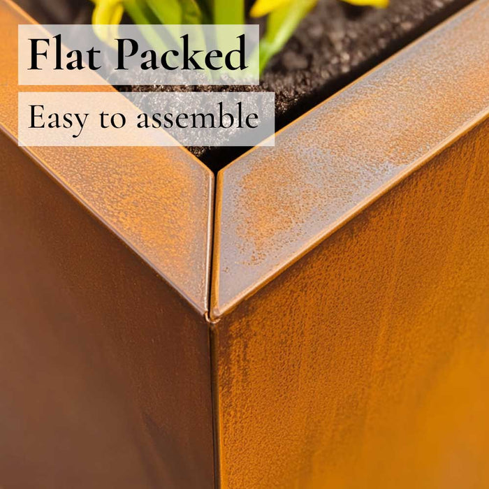 Close up of metal planter box with text 'Flat Packed, Easy to assemble' on a blurred background