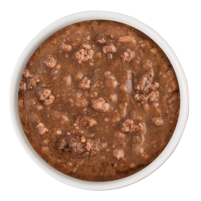 A white bowl filled with Soulistic Beef Dinner in Gravy, made with high-quality protein and chunky wet food in brown gravy, viewed from above on a white background.